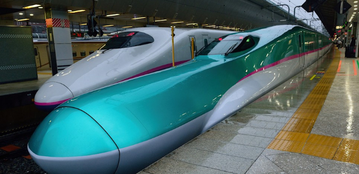 A Photo of 2 Japanese bullet Trains within a station, photo by Paul Fletcher